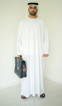 Arabic young businessman posing with bagの写真素材