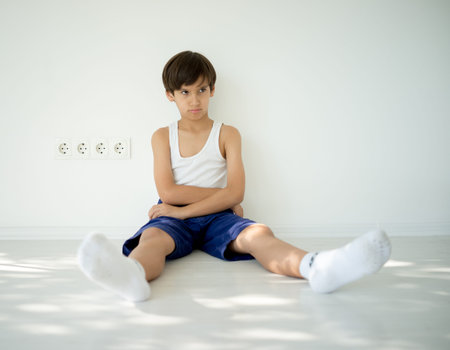 Adorable little angry boy looking asideの写真素材