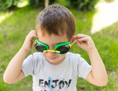 Happy summer vacation for kids on green meadow near seaの写真素材