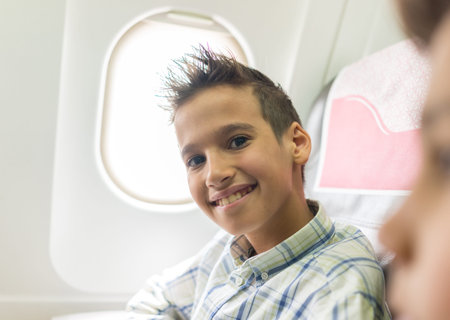 Kid traveling by airplaneの写真素材