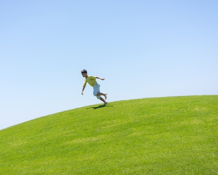 Happy summer vacation for kids on green meadow near seaの写真素材