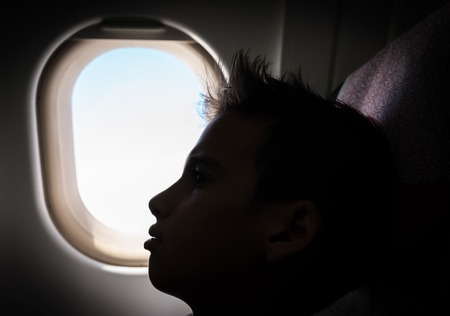 Kid traveling by airplaneの写真素材