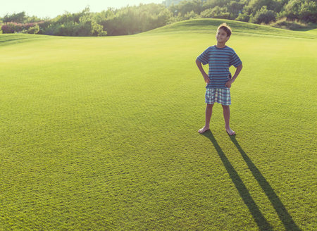 Kids with their shadows on grass