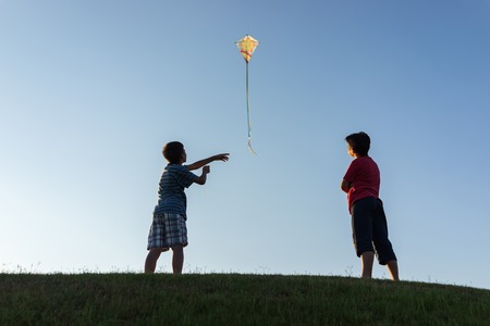 Running with kite silhouetteの写真素材