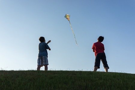 Running with kite silhouetteの写真素材