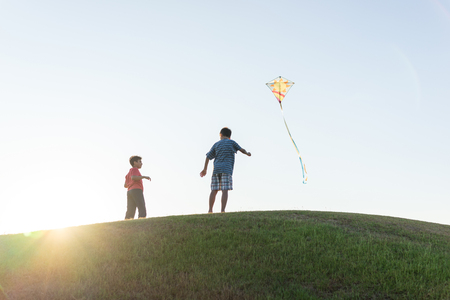 Running with kite silhouetteの写真素材