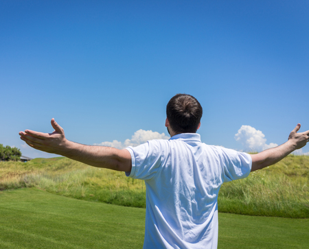 Happy summer vacation for man on green meadow near seaの写真素材