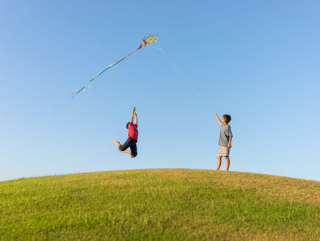 Running with kite on summer holiday vacation, perfect meadow and sky on seasideの写真素材