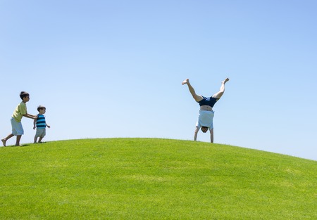 Happy summer vacation for family on green meadow near seaの写真素材