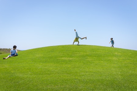 Happy summer vacation for family on green meadow near seaの写真素材