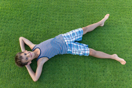 Happy summer vacation for kids on perfect meadow grassの写真素材