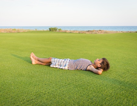 Happy summer vacation for kids on perfect meadow grassの写真素材