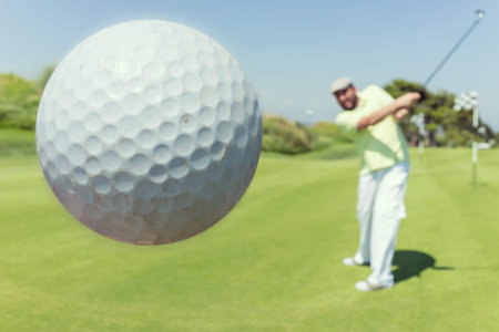 Man playing golf at clubの写真素材