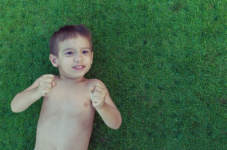 Happy summer vacation for kids on perfect meadow grassの写真素材