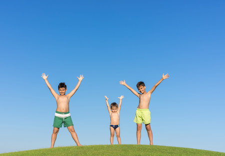 Happy summer vacation for kids on green meadow near seaの写真素材