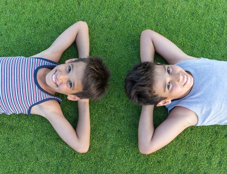 Happy summer vacation for kids on perfect meadow grassの写真素材