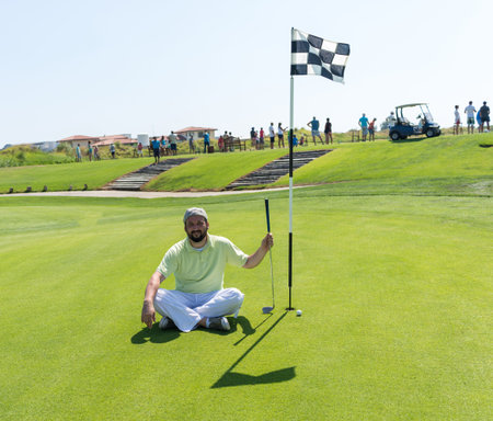 Man playing golf at clubの写真素材