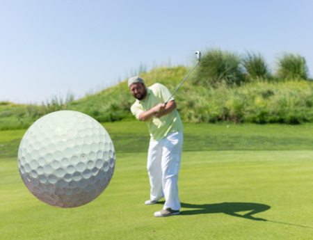 Successful man playing golf at clubの写真素材