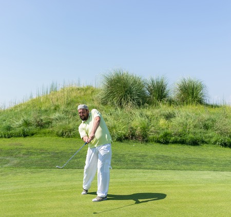 Successful man playing golf at clubの写真素材