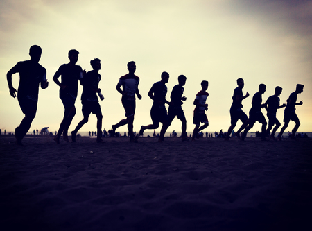 Team training of young boys on the sunset beachの写真素材