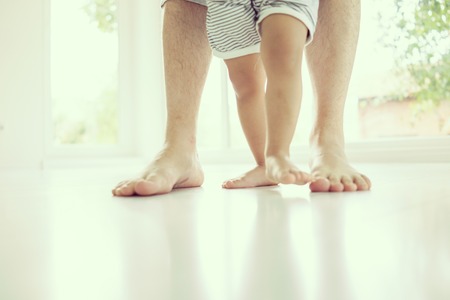 Parenting feet with baby walking stepsの写真素材