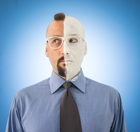 Conceptual two sides face portait photo of a businessmanの写真素材
