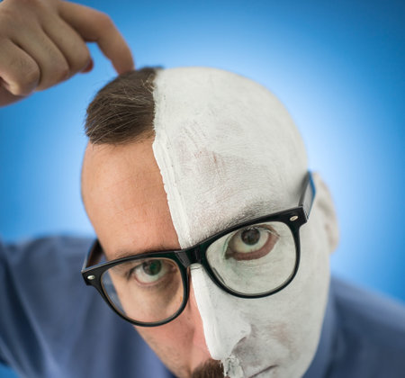 Conceptual two sides face portait photo of a businessmanの写真素材
