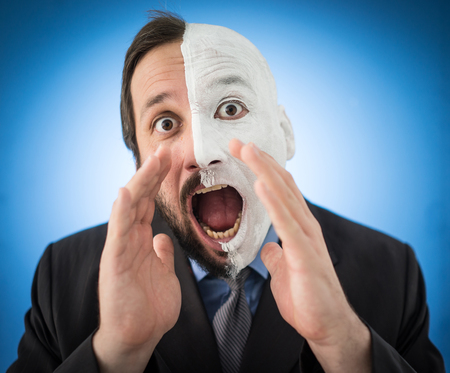 Conceptual two sides face portait photo of a businessmanの写真素材