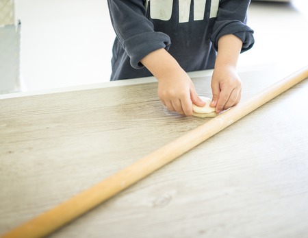 Little kid at home making foodの写真素材