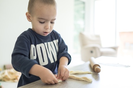 Little kid at home making foodの写真素材