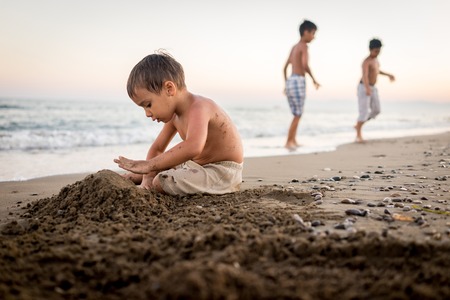Kids playing in beach sandの写真素材