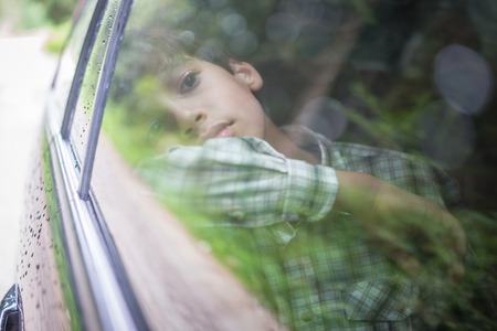 Happy kids travel by the carの写真素材