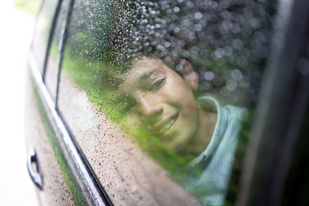 Happy kids travel by the carの写真素材