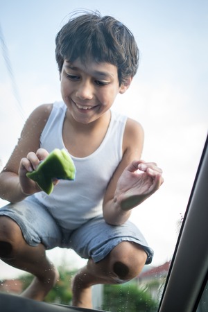 Young father and little boys washing car in summer dayの写真素材