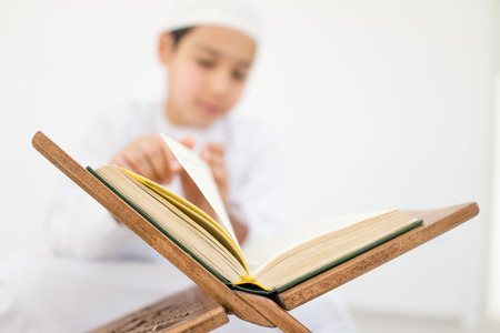 Happy kids reading Koranの写真素材