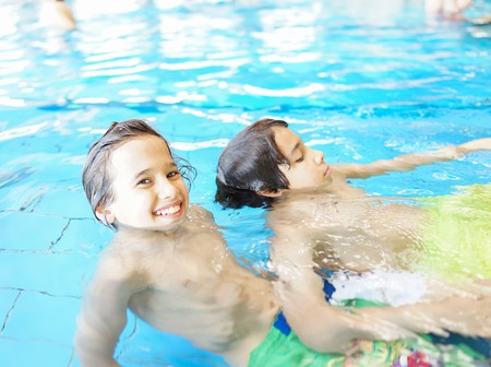 Child on summer swimming pool vacation having fun and happy life timeの写真素材