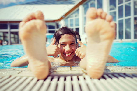 Child on summer swimming pool vacation having fun and happy life time
