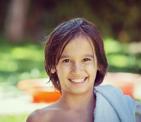 Happy children on summer garden having fun and happy time brushing teeth after outdoor bathの写真素材