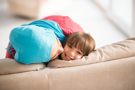 Young woman with little kid at homeの写真素材