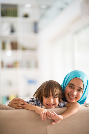 Young woman with little kid at homeの写真素材
