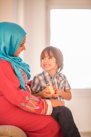 Young woman with little kid at homeの写真素材