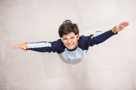 Cute kids posing from above angle on groundの写真素材