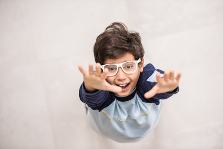 Cute kids posing from above angle on groundの写真素材