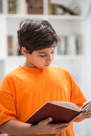 Kid with book at homeの写真素材