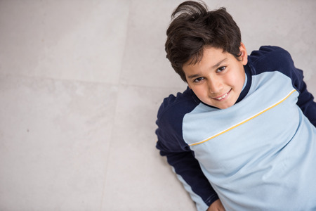 Cute kids posing from above angle on groundの写真素材