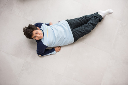 Cute kids posing from above angle on groundの写真素材