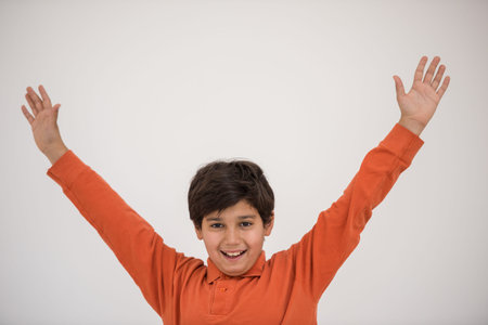 Cute school kid posing in studio with different facial expressionsの写真素材