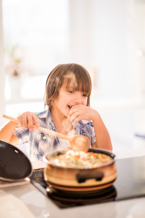 Cute adorable little boy in the kitchenの写真素材