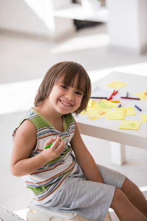 Cute boy drawing at homeの写真素材