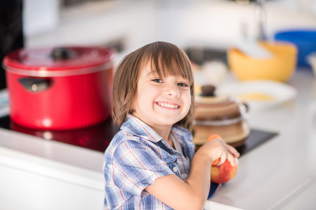 Cute adorable little boy in the kitchenの写真素材